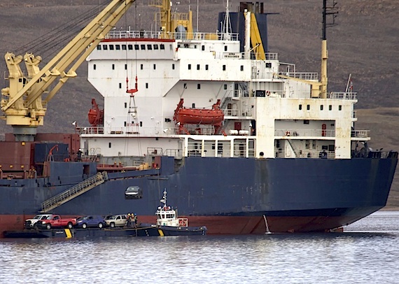 Thousands of kilometres away from the nearest car dealer, a new vehicle dangles in mid-air as it's offloaded from a sealift vessel Aug. 27 in Arctic Bay. (PHOTO BY CLARE KINES)