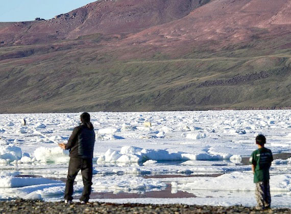 Only in Arctic Bay can you play golf and at the same time keep your eye on a polar bear. Here Tom Naqitarvik takes swings his club while practicing at an area called Victor Bay, five minutes from Arctic Bay, July 31 at about 8:30 p.m. (PHOTO BY JACK WILLIE)