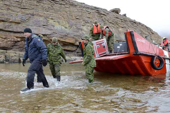 Members of the Arctic Response Company Group from 35 Canadian Brigade Group and RCMP 0fficers loading equipment from the Coast Guard ship near Iqaluit during Operation Nanook 2013 on Aug. 22, the day the exercise wrapped up. (PHOTO BY CAPTAIN DENNIS NOEL, PUBLIC AFFAIRS, DND OTTAWA)