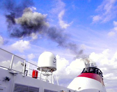 Soot particles from ships' exhaust, such as those in the plume shown here, fall to the ground in the Arctic where they draw in heat. (FILE PHOTO)