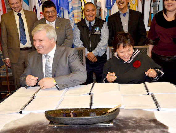 Tom Paddon (left,) president and chief executive officer of the Baffinland Iron Mines Corp. and Okalik Eegeesiak, president of the Qikiqtani Inuit Association, sign an Inuit impact and benefit agreement and commercial production lease Sept. 6 at the Discovery Lodge in Iqaluit for Baffinland's proposed Mary River iron mine project on northern Baffin Island. “This is a historic deal for Inuit of the Qikiqtaaluk region and for all of Nunavut and has the potential to positively change the economic and social fabric of the territory,