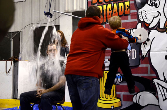 Iqaluit city councillor Kenny Bell's son soaks his dad with a little help from his uncle at the balloon splash event held Sept. 28 at the Iqaluit Rotary Club's annual fall fair.