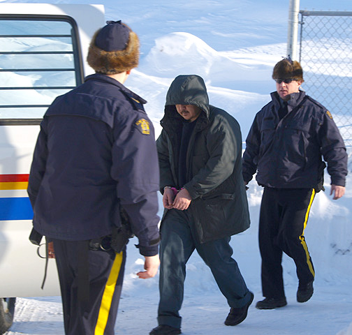 Pingoatuk Kolola, centre, is led from the Nunavut Court of Justice in 2010 after being sentenced to life in prison with no chance of parole for 25 years for killing RCMP Const. Douglas Scott in 2007 in Kimmirut in November 2007. (FILE PHOTO)