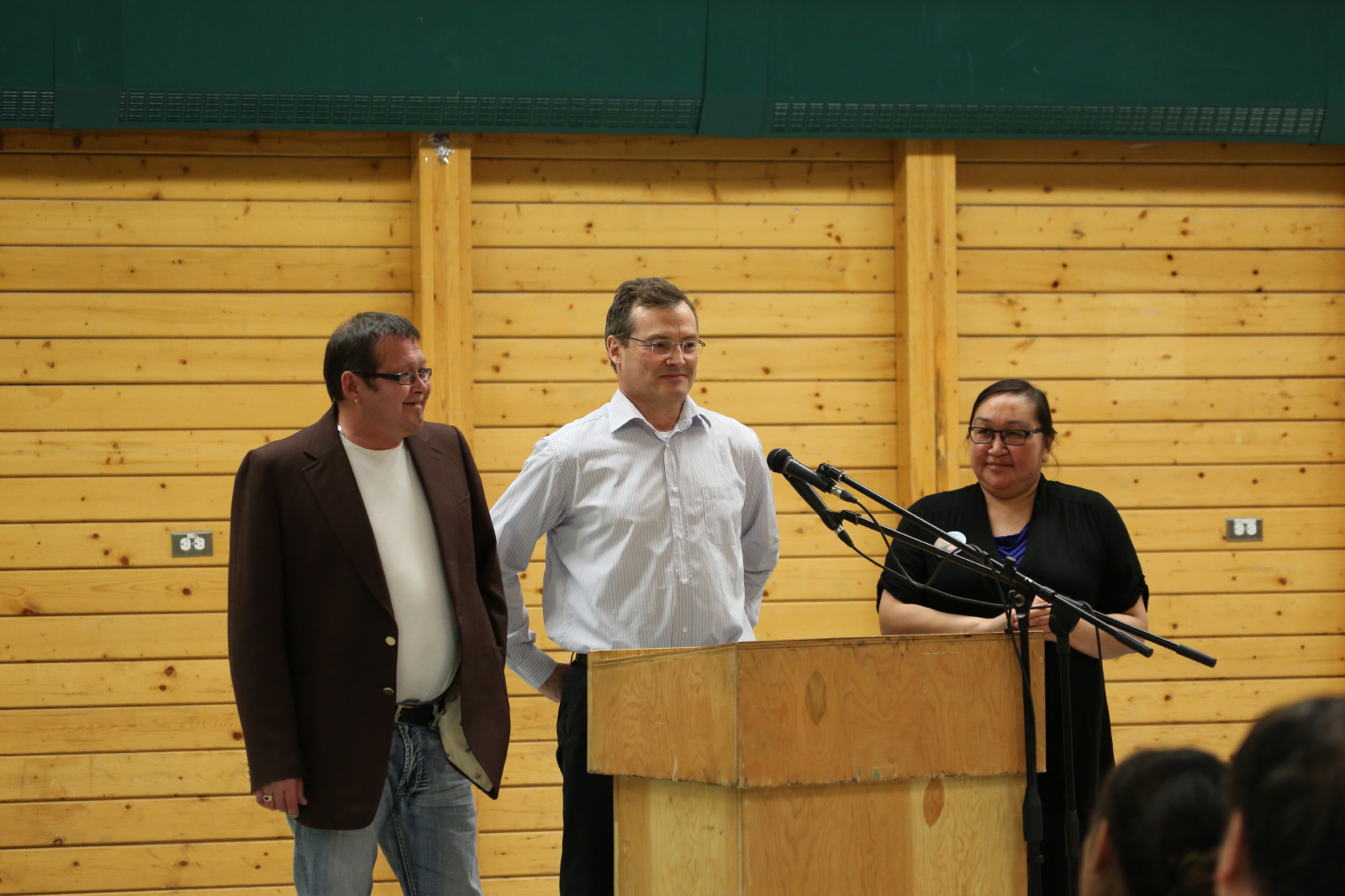 Cambridge Bay candidates, from left: Fred Pedersen, Keith Peterson and Clara Evalik respond to a question about their favourite brand of ski doo at an all-candidates debate Oct. 15. The question drew laughter from the audience at the Luke Novoligak community hall. Voters go the polls Oct. 28. (PHOTO BY RED SUN PRODUCTIONS)
