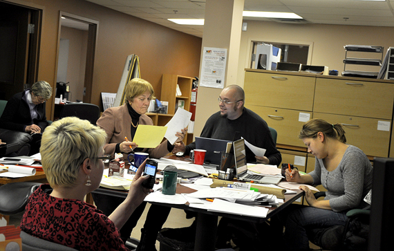 Nunavut's chief returning officer Sandy Kusugak, on the left, processing voting results Oct. 28 at the Elections Nunavut headquarters office in Rankin Inlet. (PHOTO BY SARAH ROGERS) 
