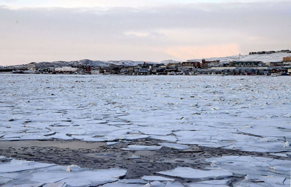 The sun starts to set just after 2 p.m., Nov. 14 in Iqaluit, where ice is beginning to form on the bay — meaning the season for travel by snowmobile down the bay isn't far away. Snow is forecast over the weekend for Nov. 16 and Nov. 17  (PHOTO BY DAVID MURPHY)  