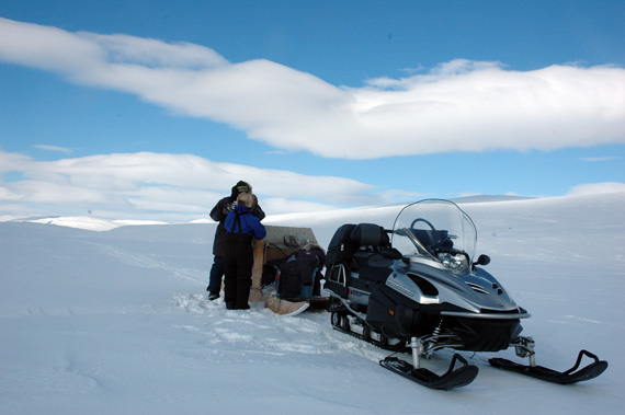 This photo captures the sinking snowmobile before it was completely lost under water near Cambridge Bay. (PHOTO BY RED SUN PRODUCTIONS)