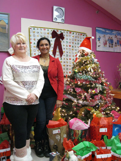 Suny Jacob, executive director of YWCA Agvvik Nunavut, right, and Rosemary Wall, director of the Qimaavik women’s shelter, with the first batch of gifts they prepared, Dec. 11, for the YWCA’s Christmas Eve dinner, Dec. 24 at the community soup kitchen. (PHOTO BY PETER VARGA)