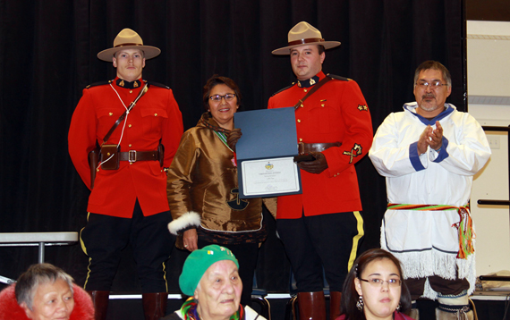 Corporal Johnathan Saxby of Baker Lake, second from right, receives a Commissioner of Nunavut award from the commissioner herself, Edna Elias, second from left, at a ceremony Nov. 26. The two are flanked by Constable Jason Briggs, at left and Baker Lake Mayor Joe Aupaluktuq. Saxby was recognized for his work with the youth of Cape Dorset to help and build the local Seewald Park. Saxby helped gather resources and grants to build the park's outdoor rink. (PHOTO COURTESY OF THE RCMP)