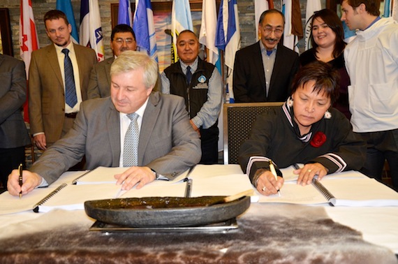 Baffinland president and CEO Tom Paddon, at left and QIA president Okalik Eegeesiak sign an Inuit impact and benefit agreement for the Mary River project last September in Iqaluit. (FILE PHOTO)