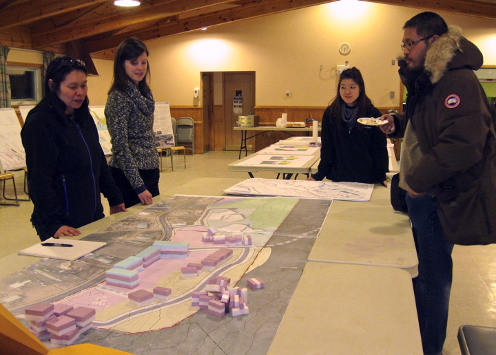 Madeleine Redfern of Ajungi Arctic Consulting, left, and urban planner Michelle Drylie of Planning Alliance, beside Redfern, hosted a public consultation Feb. 19 on Qikiqtaaluk Corp.’s Federal Rd. development project. Residents at this table got to show their preferred layout for buildings in residential areas. (PHOTO BY PETER VARGA)