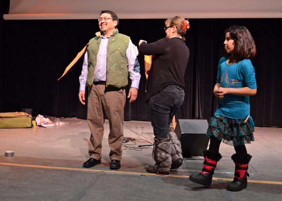Vicky Johnston, centre, and Louisa Makiuk, at right, dress up Kuujjuaq mayor Tunu Napartuk like a bird Feb. 12, to illustrate how birds adapt to survive the cold of the Arctic. The trio took part in an event hosted by the Arctic Council's Conservation of Arctic Flora and Fauna working group, which is meeting in Kuujjuaq this week. The bird-themed evening, held at the local Katittavik town hall, also featured a screening of the film People of a Feather, which explores the relationship between the Inuit of Sanikiluaq and the eider duck. (PHOTO BY ISABELLE DUBOIS) 
