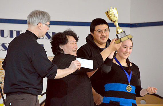 Jeannie Puxley, a Secondary 5 student from Salluit, receives a trophy Feb. 26 after she took top honours in Nunavik's regional science fair, held in her hometown. Puxley's winning project was a light therapy booth she built for southerners who have trouble adjusting to the few hours of sunlight available during the Arctic winter. Read more about the winners at Nunatsiaqonline.ca. (PHOTO COURTESY OF THE KSB)