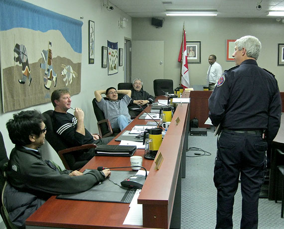 Luc Grandmaison, Iqaluit’s fire chief and head of the emergency services department, congratulates some city councillors for finally passing the City of Iqaluit’s 2014 budget, March 11. Grandmaison’s department, like others, had to cut expenses to limit this year’s tax increase. Chatting with the fire chief are councillors Noah Papatsie and Terry Dobbin, who pushed for lower increases than rates favoured by other members, including Joanasie Akumalik and Simon Nattaq, seated to the right. (PHOTO BY PETER VARGA)