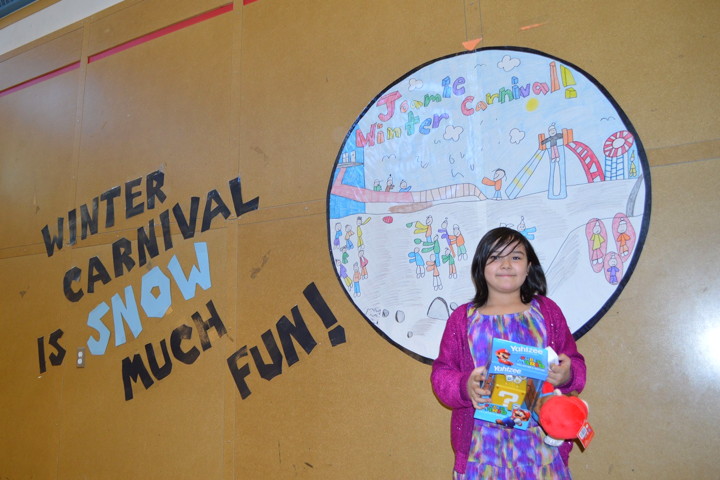 Students at Joamie School in Iqaluit are getting a break from the humdrum of March and enjoying the annual winter carnival, especially Grade 3 student Hannah Durdle Awa, above, whose artwork was chosen to adorn this year's carnival button. Awa earned a prize for winning the button contest and organizers then made 300 buttons with her design. Still ahead in the week-long carnival: snow sculpture judging, a culture fair, and the 