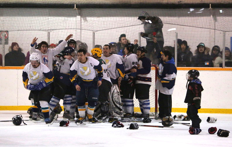 The Gjoa Haven Snowy Owls celebrate their win over Cambridge Bay in the final game of this year's Kitikmeot Cup hockey tournament March 16 in Cambridge Bay. An enthusiastic audience packed the Ookpik Youth Community Arena to brimming to witness the final 6-1 victory. (PHOTO BY RED SUN PRODUCTIONS)