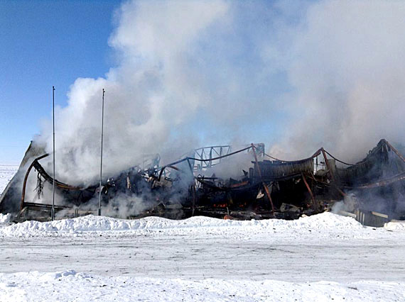 By noon March 15, the school had been reduced to a smoking pile of twisted metal. (PHOTO BY QULLIK CAIN)