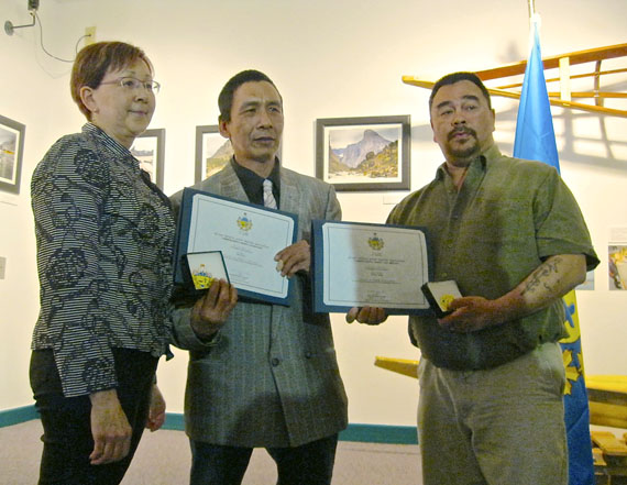 Billy Kownirk, centre, and Pitseolak Alainga were among eight Iqalummiut who received Nunavut Commissioner’s Awards at Iqaluit’s Nunatta Sunakkutaangit Museum April 17. Deputy commissioner Nellie Kusugak, left, presented awards for acts of bravery and volunteerism on behalf of commissioner Edna Elias. The two men received the honour for saving each others' lives during a boating accident on Frobisher Bay in the fall of 1994, when eight other Iqaluit men perished. The most recent award for bravery went to Mathew Knickelbein for helping fellow Apex residents who went without power during a blizzard this past Jan. 7 and Jan. 8. Awards for volunteerism went to Judy Grace Gabuna for her contribution to the Anglican Church and the community soup kitchen, and to Ed McKenna for his contribution to the work of the soup kitchen. (PHOTO BY PETER VARGA)