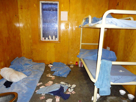 Welcome to the Nunavut Hilton. This behavioural unit at the Baffin Correctional Centre was originally designed for one inmate. Now it holds three. The original drywall is now mostly covered with plywood and the old flooring has been stripped off to uncover a bare cement floor. To fit three inmates into this cell, a mattress lies on the floor next to the toilet. The Correctional Investigator of Canada says BCC is unsafe for staff and inmates alike and should be shut down. Read more on nunatsiaqonline.ca. (PHOTO: OFFICE OF THE CORRECTIONAL INVESTIGATOR)