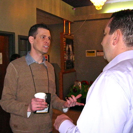 Chris Bertoli, superintendent of electrical and instrumentation for the Diavik diamond mine, chats with a delegate at the Nunavut Mining Symposium in Iqaluit, April 10, where he described the success of the mine’s wind turbine power-generation project. (PHOTO BY PETER VARGA)