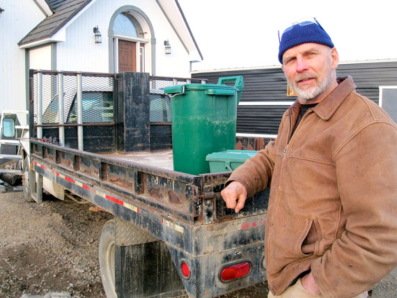 Arctic compost pioneer Jim Little used to collect household waste for compost from households in Iqaluit between 2004 until the start of 2013. He hopes to demonstrate the project to the city once again. Participating households used to gather their waste in green bins, pictured, which he then loaded into a similar pickup truck. (PHOTO BY PETER VARGA)