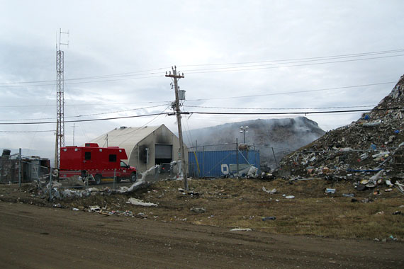 The City of Iqaluit’s dump fire smoulders within a 10-metre-high garbage pile June 8. Westerly winds blowing smoke into into the city have caused school closures and health concerns among residents. The Government of Nunavut says Environment Canada and Health Canada will provide equipment to assess air quality in the city. (PHOTO BY PETER VARGA) 