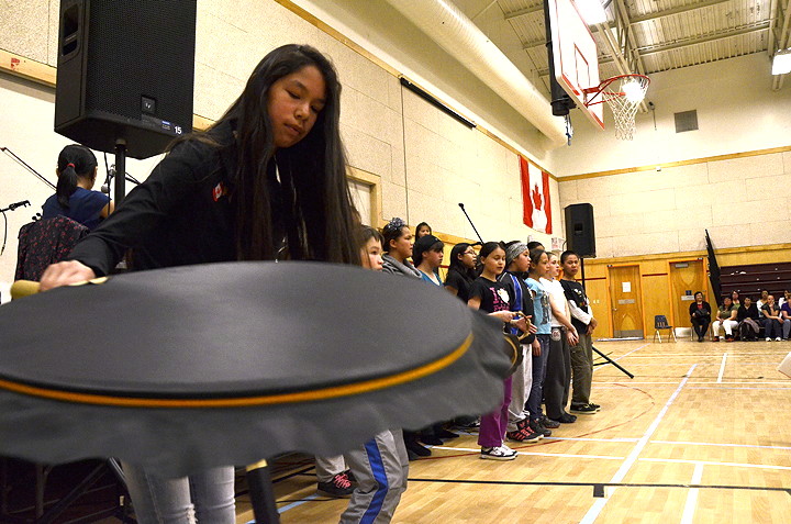 Shawna Kyak drums alongside Iqaluit's Aqsarniit Middle School choir and band. The school performed a song of their own creation called 