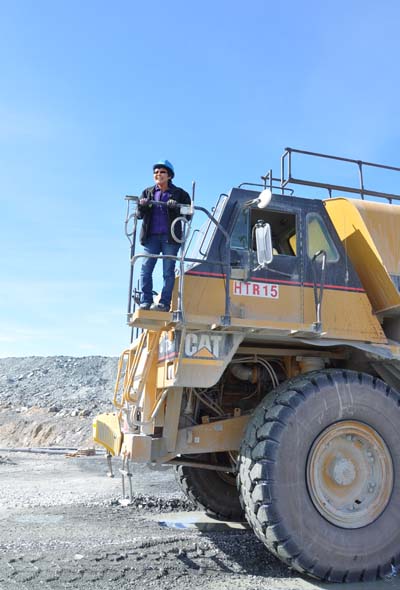 Blandina Kashla, a haul truck driver from Baker Lake, on top of the water haul truck she’s driving through Vault pit Agnico Eagle’s Meadowbank mine June 23. (PHOTO BY SARAH ROGERS)