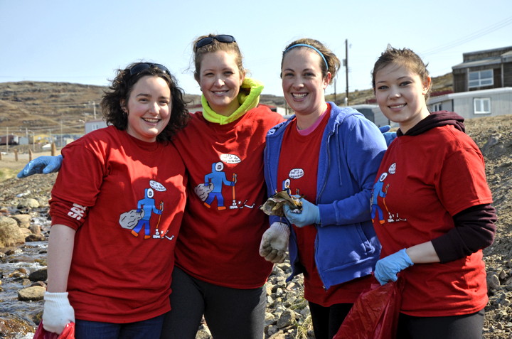 Staff from the Government of Nunavut's department of health help clean up a creek near the breakwater June 20 for Iqaluit's community clean-up day. From left: Linnea Ingebrigtson, Michelle Issaluk, Stephanie Grant and Megan Blair. “It’s a great opportunity to be outdoors and clean up the community and help out,” Ingebrigtson said. The clean up was supposed to be held a week ago, but that was postponed until today due to heavy smoke from the dump fire. (PHOTO BY DAVID MURPHY)