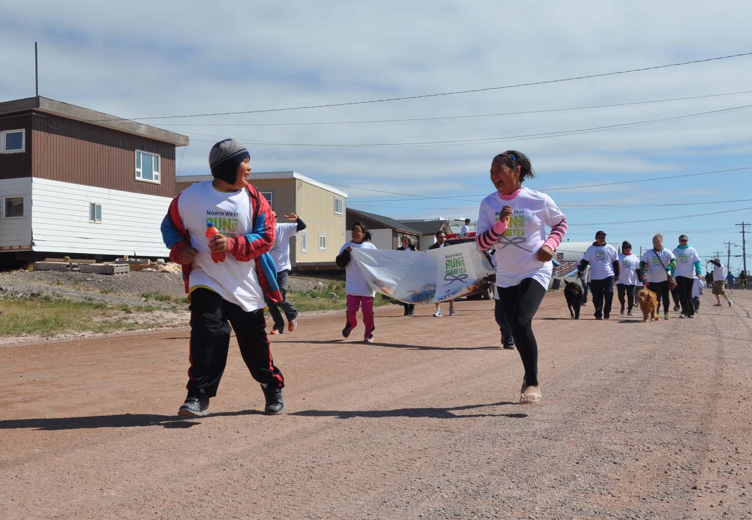 Youth in Baker Lake kick off the annual Run for Diabetes on a sunny first day of summer. As part of the Northwest Company sponsored event, a few dozen residents walked or ran to the airport and back (PHOTO BY SARAH ROGERS) 