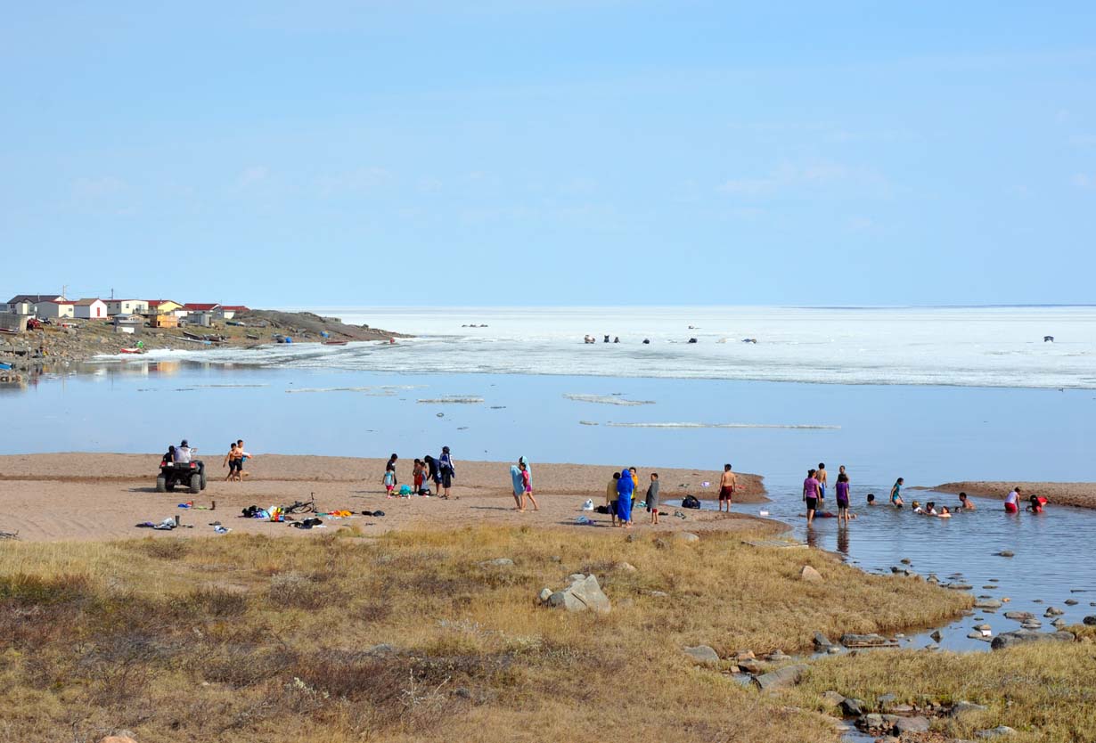 Children cool off along the thawed shoreline of Baker Lake June 20, as temperatures rose above 20C. Weather in most of the Kivalliq region has been sunny and hot, with more of the same forecasted over the weekend. (PHOTO BY SARAH ROGERS)
