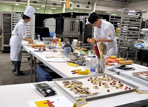 Terri Angalik, left, a member of Arviat's Skills Nunavut baking club, works to prepare a pie crust at the International Centre in Mississauga, Ont. June 5. That's where students from different Skills Nunavut groups are competing with clubs from across the country this week. Some of Angalik's finished products are on display for judging: short bread and piped butter cookies. Read more about Skills Nunavut's participation at the national event later at Nunatsiaqonline.ca. (PHOTO BY SARAH ROGERS)