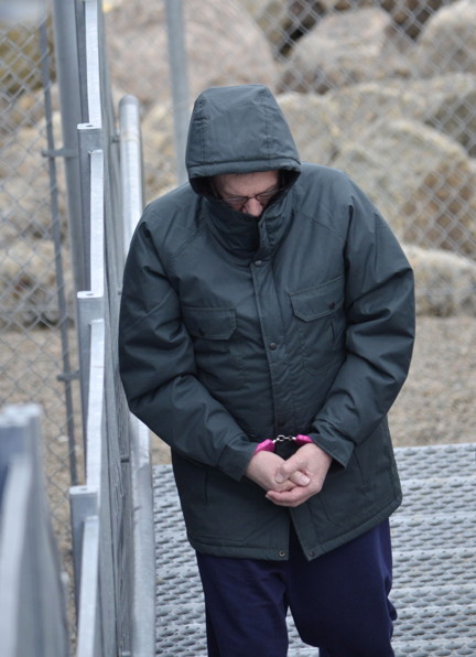 Eric Dejaeger, on May 26, being lead into the Nunavut Court of Justice in Iqaluit. (FILE PHOTO)