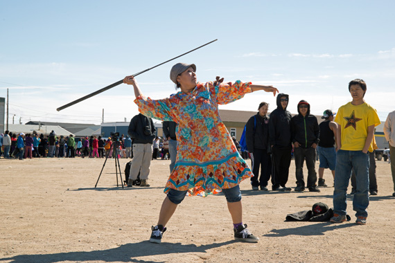 Jessie Tologanak takes aim as she participates in the harpoon throwing contest July 9 at Cambridge Bay's Killinik baseball field. Harpoon throwing was one of a number of traditional events held as part of Nunavut Day celebrations in the Kitikmeot community. (PHOTO BY DENISE LEBLEU IMAGES) 