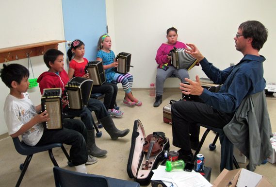 Fiddle and accordion instructor Greg Brown directs a group of beginner accordion players at the Iqaluit Music Society’s 19th annual Music Camp at Nakasuk School in Iqaluit, Aug. 22. Brown came from the National Arts Centre in Ottawa to join 15 other instructors in the week-long camp, which included instruction in piano, guitar, percussion, drum-dancing and throat singing. (PHOTO BY PETER VARGA)