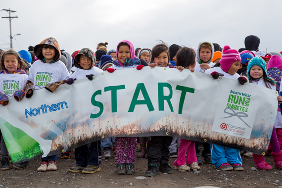 Kugluktuk school children pose at the starting line of the Terry Fox Run Sept. 5. Dozens of youth ran through the Kitikmeot community in support of Diabetes research. (PHOTO BY JESSE AJAYI) 
