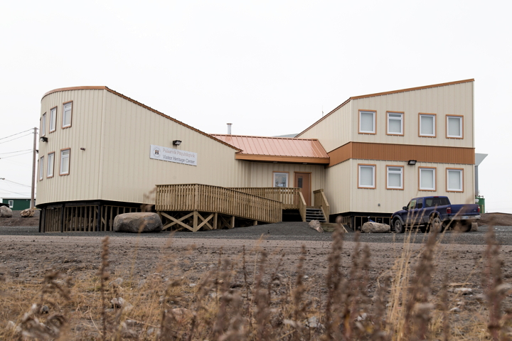 A view from the outside: Kugluktuk residents cut the ribbon on their new ulu-shaped heritage visitor's centre Sept. 18 with the help of elder Alice Ayalik and Ernie Bernhardt, the former mayor of Kugluktuk who had the original vision for the ulu building and came up with its unique design. (PHOTO BY JESSE AJAYI)