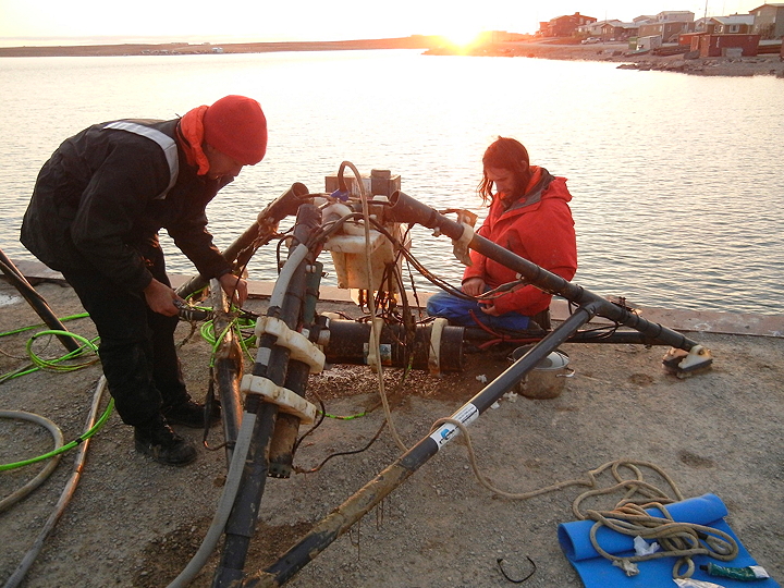 A team from the University of Victoria works late on the dock in Cambridge Bay Sept. 16 to prepare their Neptune underwater marine observatory to be moved for a thorough cleaning and repair. The device, which measures such things as underwater temperature, sounds, salinity and ice thickness, is also equipped with a camera and microphone to record what's happening on the sea floor. On the wharf, a second camera monitors surface ice formation and a small weather station records atmospheric conditions. The project is meant to provide