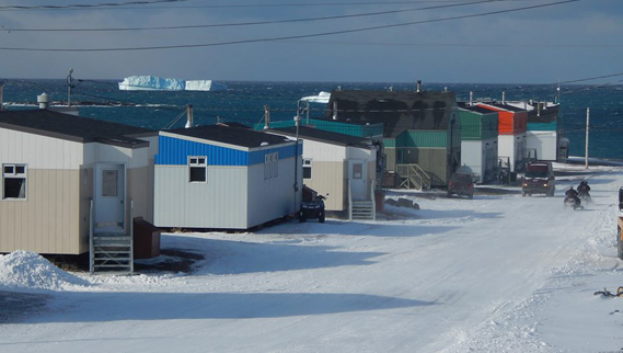 A giant iceberg overlooks the community of Quaqtaq, along Nunavik’s Ungava coast last week. (PHOTO BY CHARLIE TUKKIAPIK)