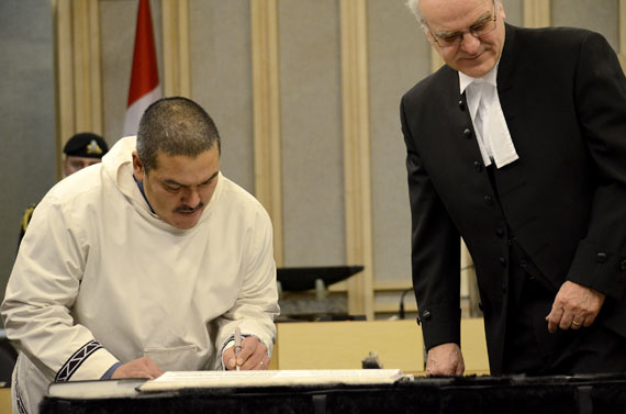 Uqqummiut MLA Samuel Nuqingaq signing his oath of office at a ceremony inside the Nunavut legislative building in Iqaluit this past Nov. 19. Since then, two successive suspensions, imposed by fellow members, have kept him from sitting in the assembly until this week. As of today, he is now an ex-MLA. (FILE PHOTO) 