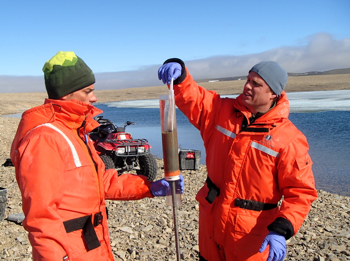 Carleton University's Murray Richardson, left, and John Chételat, with Environment Canada, sample sediment for mercury from a polar desert lake at Resolute Bay in July 2014. (PHOTO COURTESY JOHN CHETELAT)