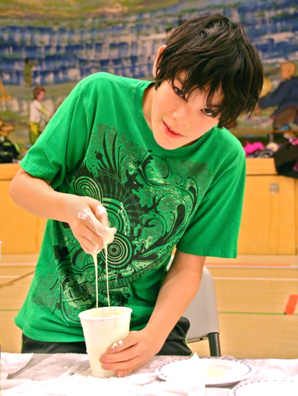 Sebastian Qaumriaq, 11, plays with the liquid state of oobleck goo that he made at a CHARS science camp in Cambridge Bay Dec. 7. (PHOTO BY KELCEY WRIGHT)