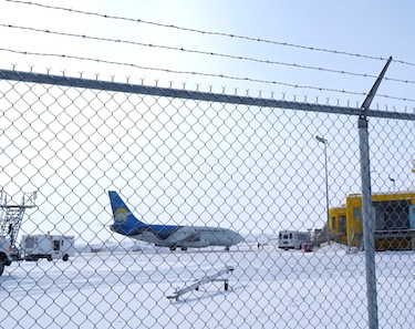 Seen behind a security fence at the Iqaluit airport, Canadian North jet waits on the tarmac March 28, two days after a new order from Transport Canada boosted security inside the all Canadian aircraft. (PHOTO BY JANE GEORGE)