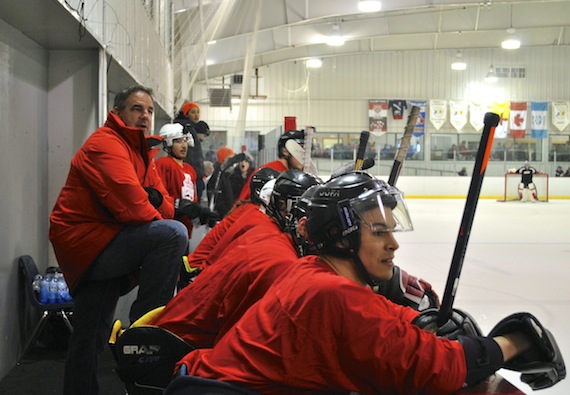 Team LeClair, headed up by none other that former National Hockey League player John LeClair, left, follows the action in a fundraising hockey game during a “celebration of hockey” event by Scotiabank, March 27, at the Arctic Winter Games arena in Iqaluit. LeClair’s team squared off against Team McSorley, coached by former NHL tough guy Marty McSorley, who won the game 6-4. Organizers billed the match-up as a “VIP” game, but “it was mostly joking,” LeClair said. The retired pro players were in the Nunavut capital to greet hockey fans with the Stanley Cup, and share tips about their favourite game with community hockey organizers and kids. Funds raised at the friendly LeClair-McSorley match-up went to support the Iqaluit food bank and YWCA Agvvik, Nunavut’s women’s shelter. Read more on Nunatsiaqonline.ca. (PHOTO BY PETER VARGA)
