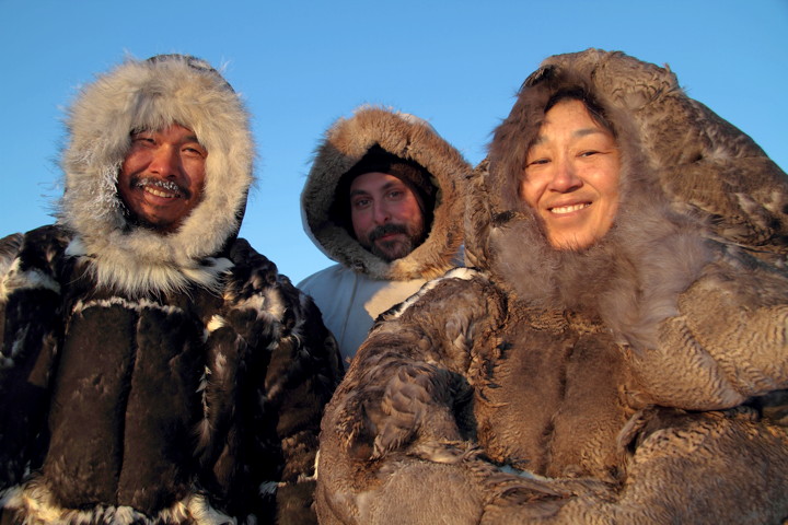 Johnassie Ippak, left, and Maria Kudluarok, right, pose with director Joel Heath wearing traditional eider skin clothing created for recreation scenes from People of a Feather. (PHOTO BY JONNY KUDLUOROK)