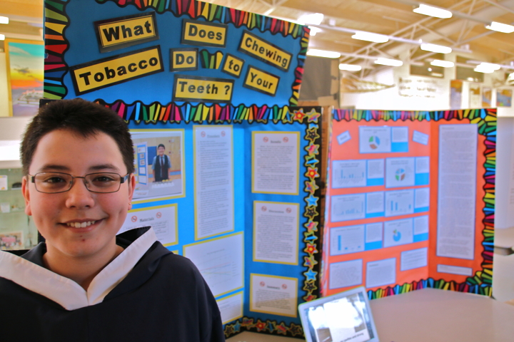 Jordan Takkiruq, winner of this year's Kitikmeot Regional Science Fair March 21, did a survey and experiment to find out which chewing tobacco and drink combination was worst for teeth. He cleaned, brushed and weighed caribou teeth once a week for seven weeks as part of his experiement and that hard work and creativity earned him this year's top prize. (PHOTO BY KELCEY WRIGHT)