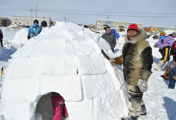 Solomon Awa, organizer for the Toonik Tyme festival’s traditional games in Iqaluit touches up his igloo, April 6, after the igloo-building contest. (PHOTO BY PETER VARGA)