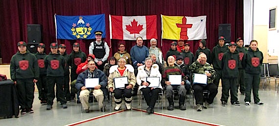 The Commissioner's awards ceremony was hosted at Pond Inlet's Attakaalik Community Hall April 15, Pictured in the back row, from left, Junior Rangers; Cst. Higgins;  Hon. Edna Elias, Commissioner of Nunavut; Joe Enook, MLA for Tununiq; Mayor Charlie Inuarak; Sgt. Titus Allooloo and Junior Rangers; middle row from left, Junior Rangers; Mr. Qiliktee (on behalf of his mother Appia Qiliktee); Lizzie Simonie; vacant; Sheati Tagak; Jessie Peterloosie; Nathan Ootoova and Junior Rangers and front row from left,  Isaac Qiyuapik, Regilee Ootook; Rhoda Pewatualuk; Gamailie Kilukishak and Ookookoo Quaraq. (PHOTO COURTESY OF THE COMMISSIONER OF NUNAVUT)