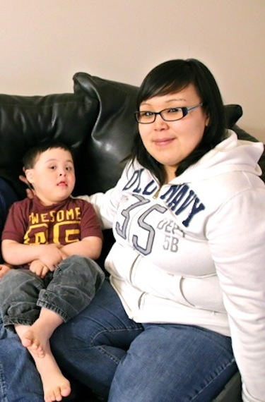 Brennan Koblogina-Pye, born with the genetic disorder Down syndrome, sits with his mother Clarissa Koblogina of Cambridge Bay. (PHOTO BY KELCEY WRIGHT)