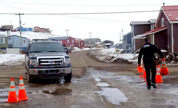 Standoff over, barricades down: Sgt. Michael Hatch of the Iqaluit Municipal Enforcement Office removes barricades from roads leading to the city's Happy Valley neighbourhood, whose residents endured a lockdown from 4 p.m. April 28 to shortly after 10 a.m. April 30. (PHOTO BY JANE GEORGE)